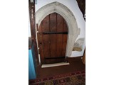 Early English vestry door with damaged 'Holy water' stoup