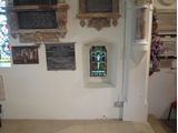 The 'leper window' from the interior, with stained glass showing the Crucifixion